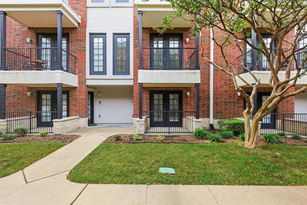 4110 Fairmount Street, Unit 1004 Dallas, TX 75219 - Photo 3 of 35 front view of a brick house with a yard and large trees