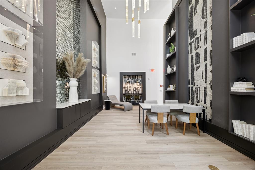 4110 Fairmount Street, Unit 1004 Dallas, TX 75219 - Photo 32 of 35 a living room with furniture a large window and wood floor