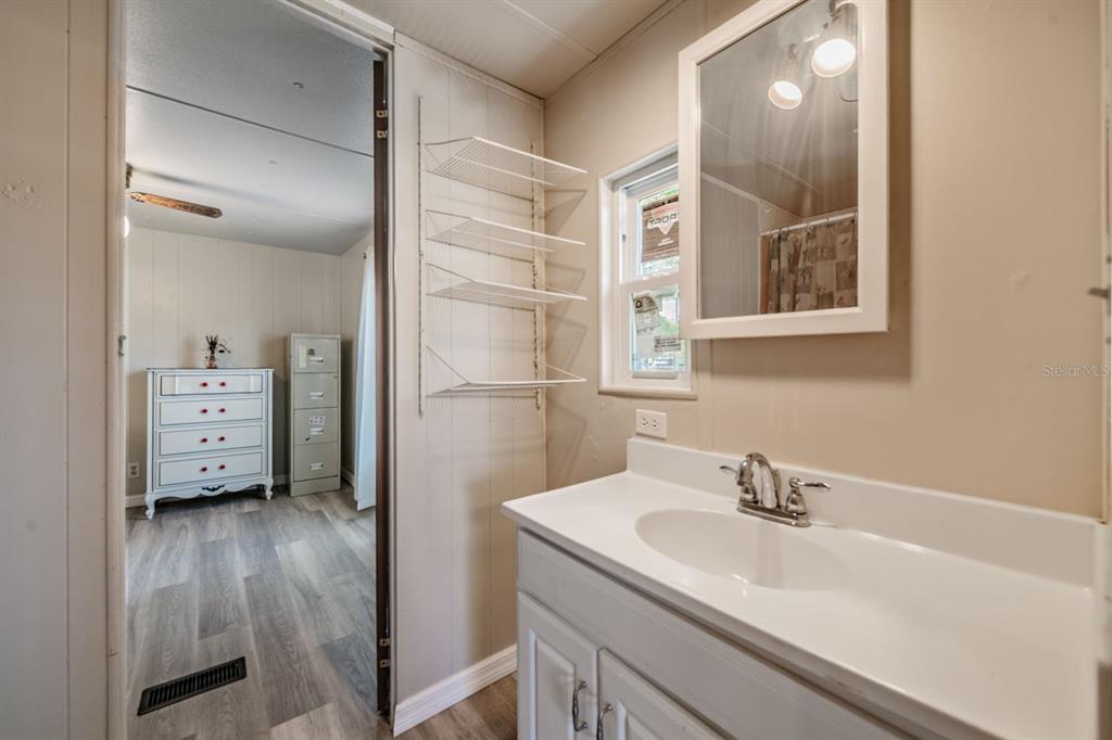9739 Ray Street Hudson, FL 34669 - Photo 26 of 36 a bathroom with a sink mirror and vanity