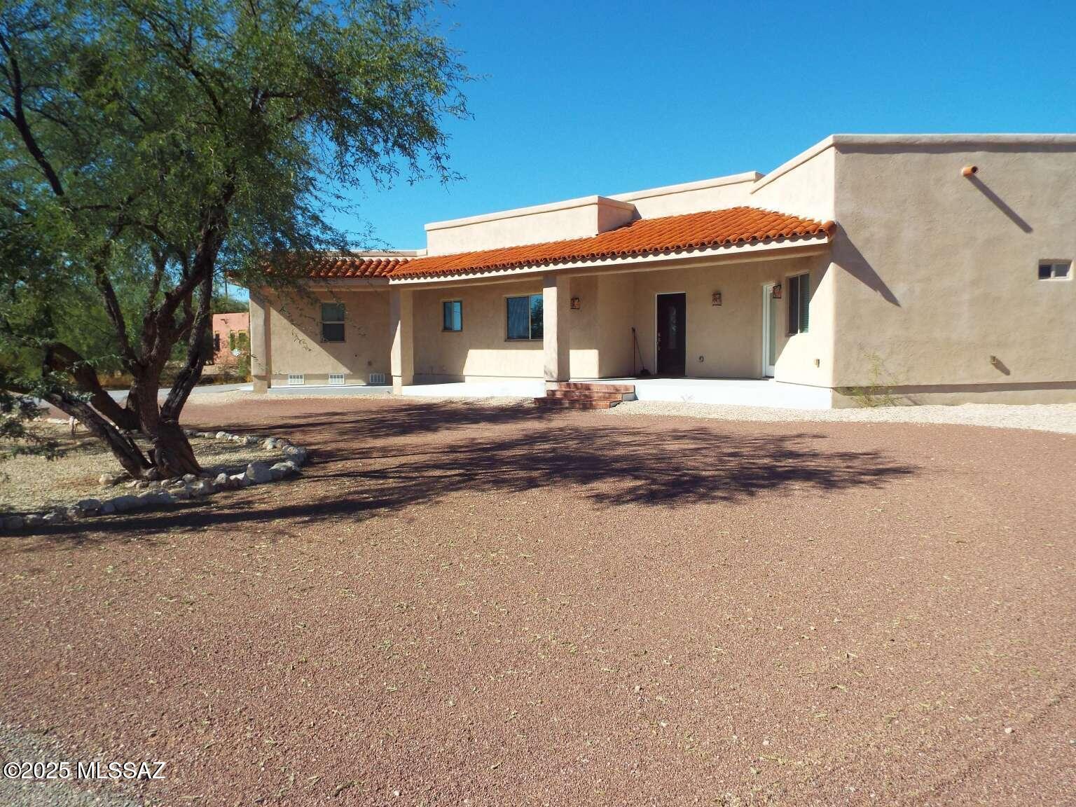 11553 East Tanque Verde Road Tucson, AZ 85749 - Photo 2 of 16 a view of a house with a yard and large tree