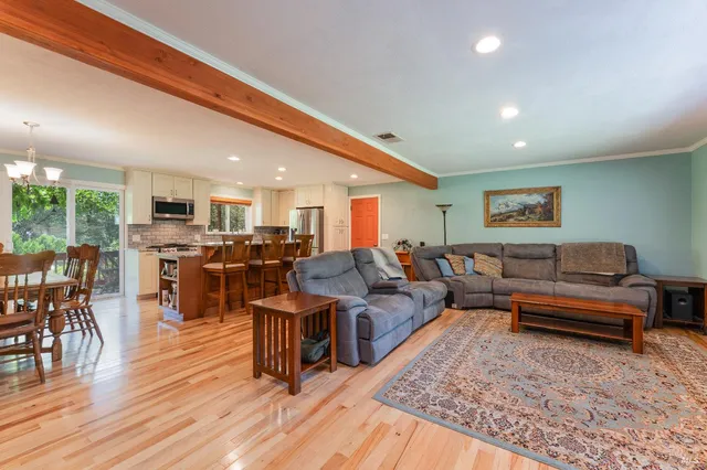 a living room with lots of furniture and kitchen view