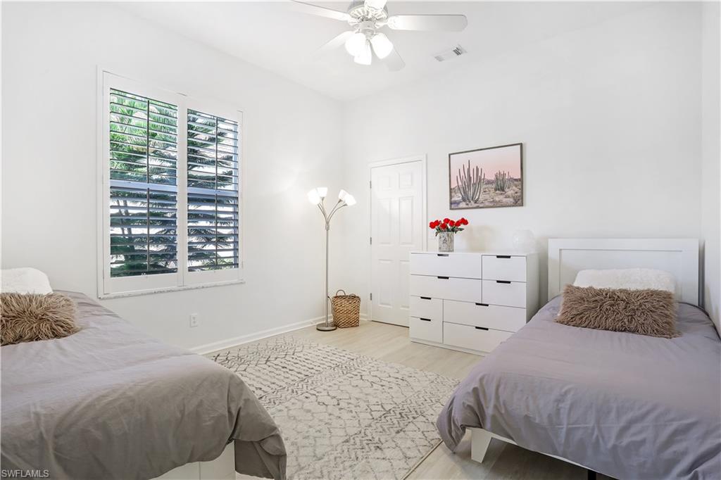7699 Groves Road Naples, FL 34109 - Photo 24 of 30 a bedroom with a bed and a window