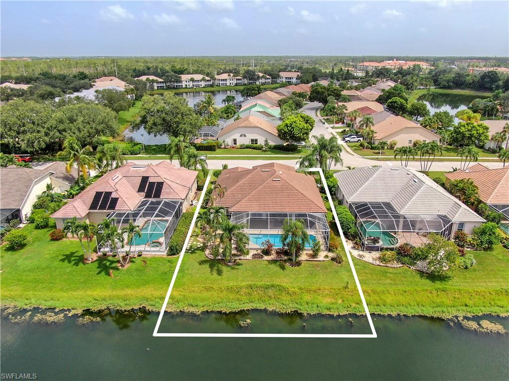 7699 Groves Road Naples, FL 34109 - Photo 3 of 30 an aerial view of residential houses with outdoor space and swimming pool