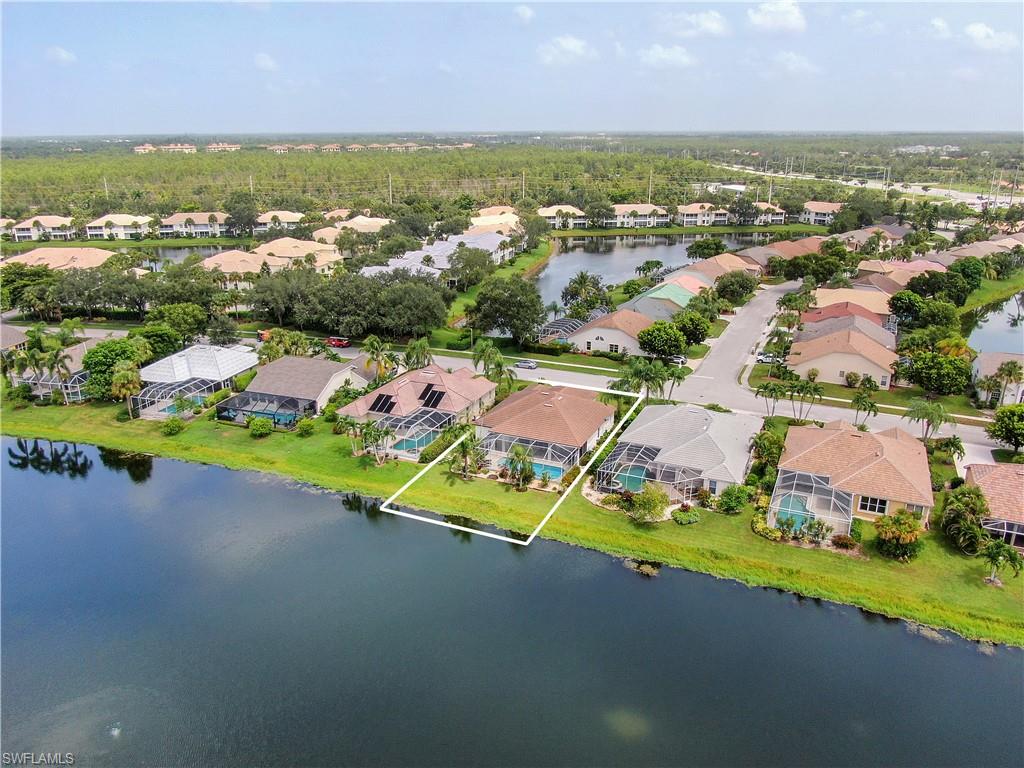 7699 Groves Road Naples, FL 34109 - Photo 4 of 30 an aerial view of a houses with a swimming pool