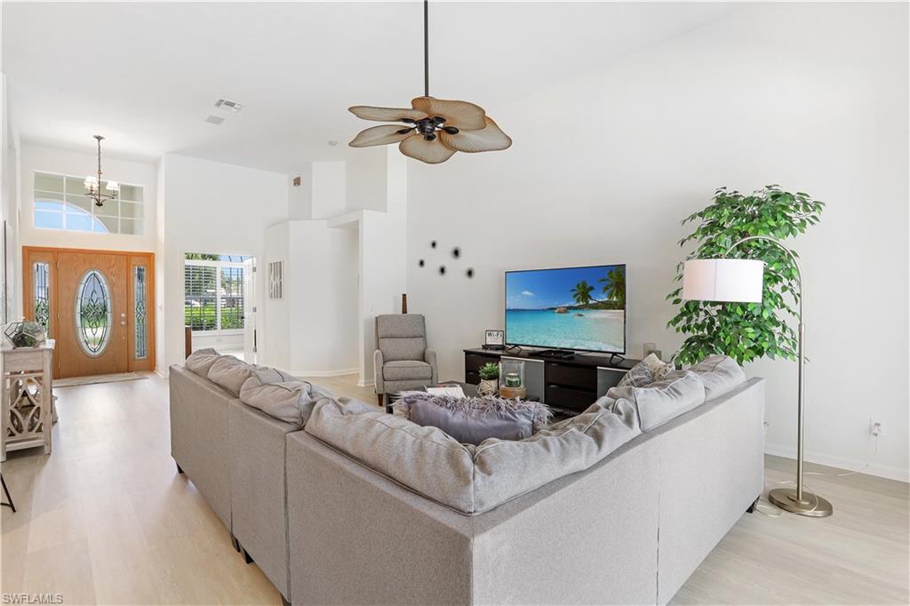 7699 Groves Road Naples, FL 34109 - Photo 9 of 30 a living room with furniture and a flat screen tv