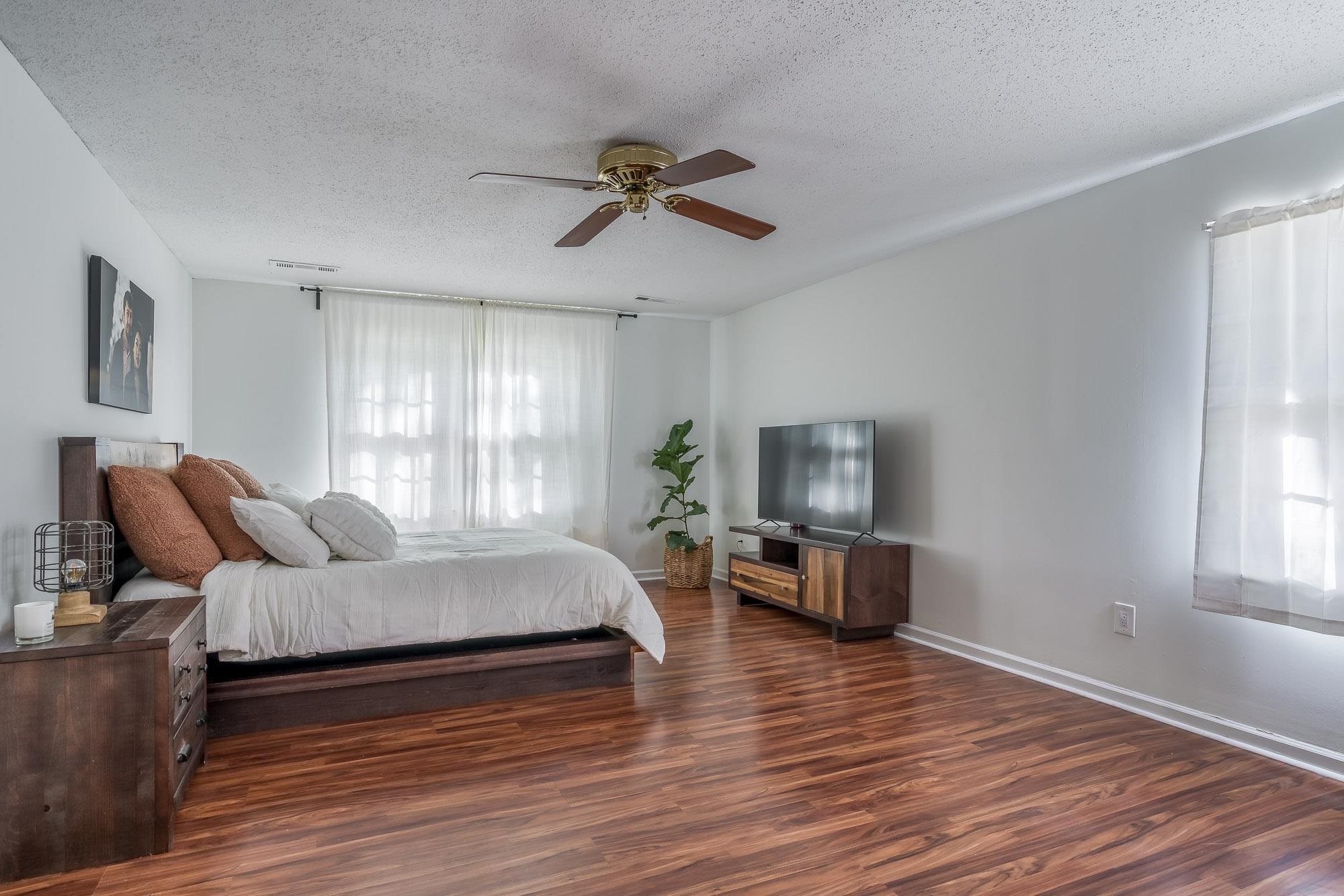 6780 Wytham Drive Memphis, TN 38119 - Photo 15 of 25 a bedroom with furniture and a wooden floor