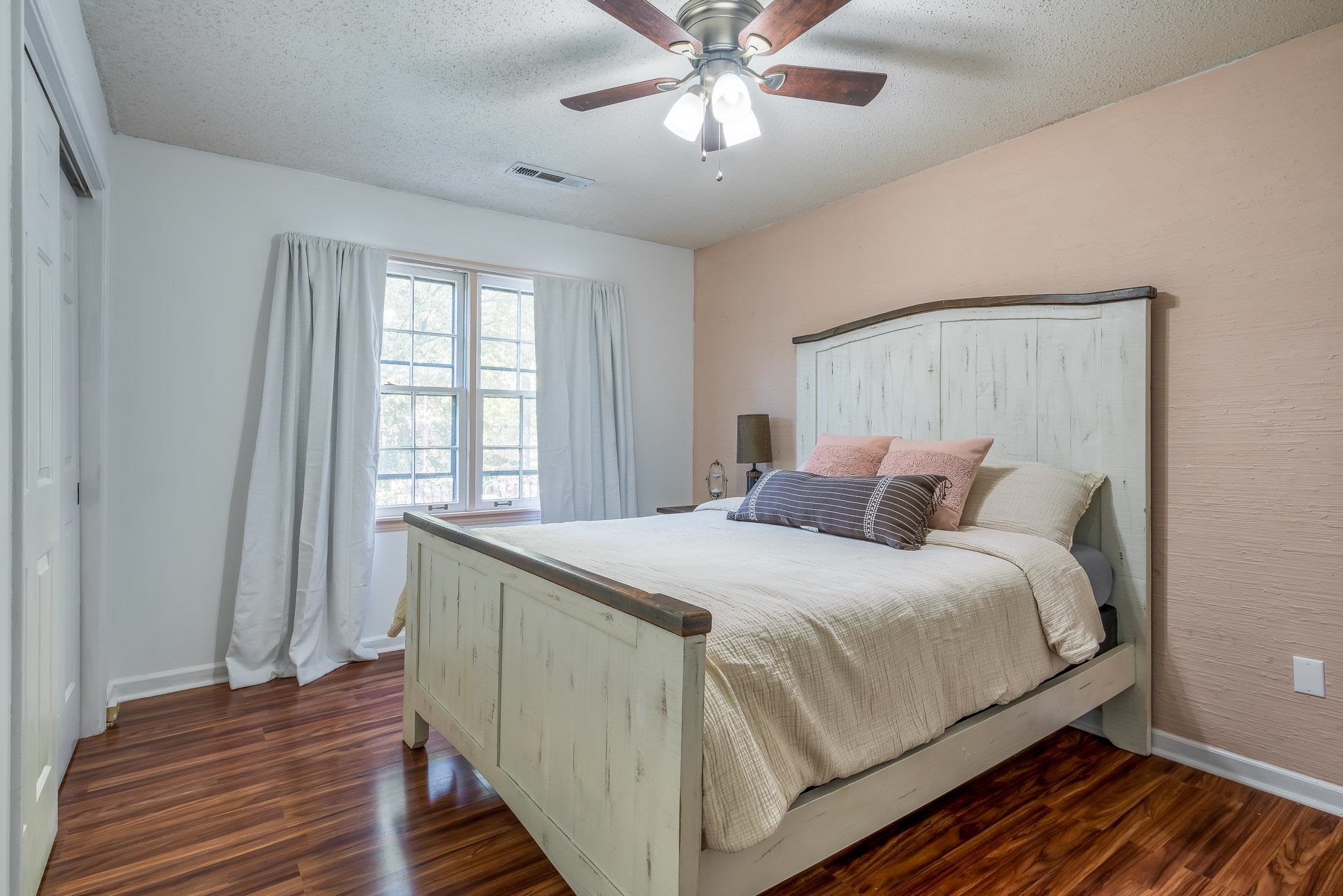 6780 Wytham Drive Memphis, TN 38119 - Photo 21 of 25 a bedroom with a bed and wooden floor