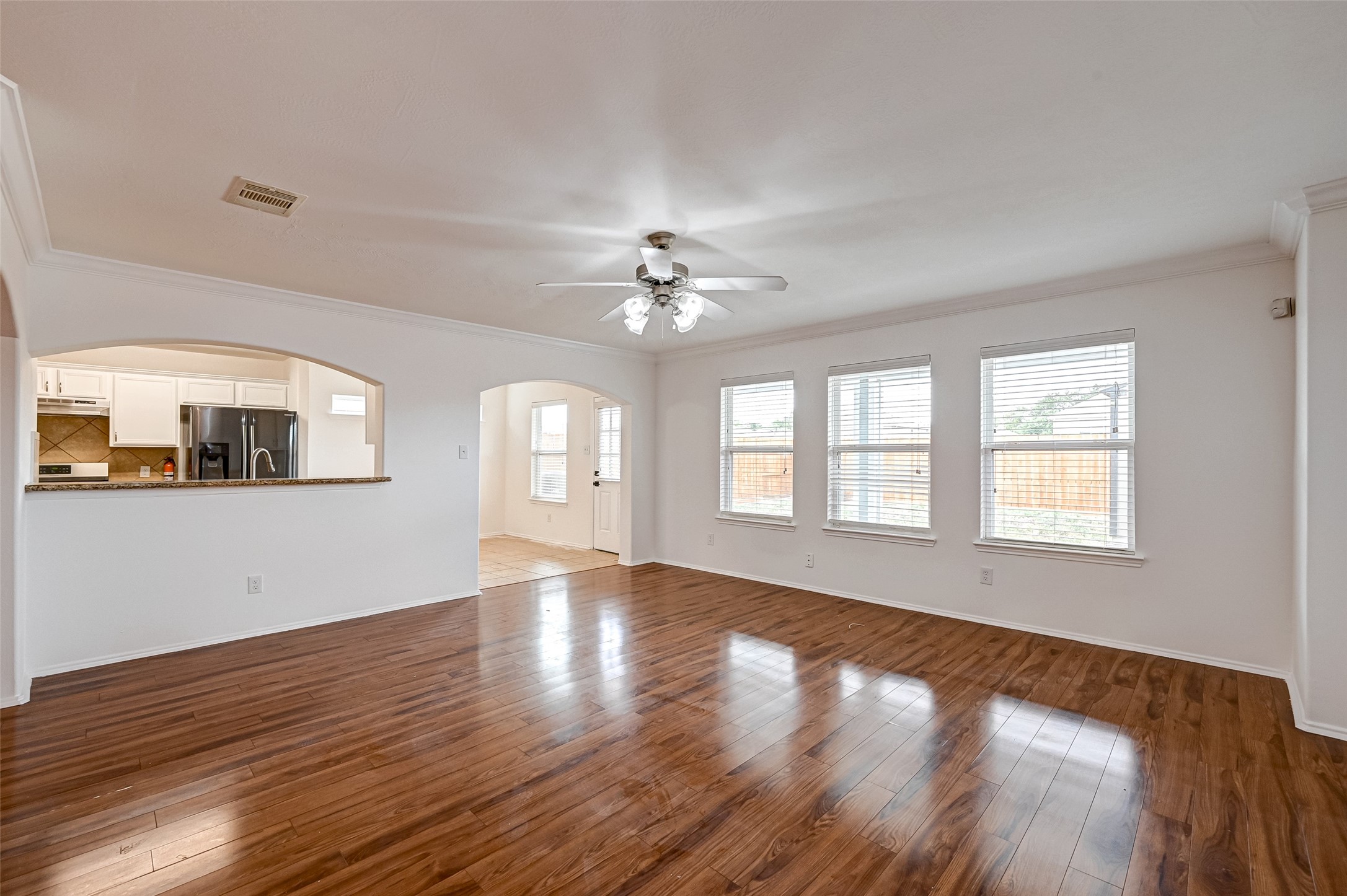 6906 Anson Point Lane Houston, TX 77040 - Photo 7 of 31 a view of an empty room with wooden floor and a window