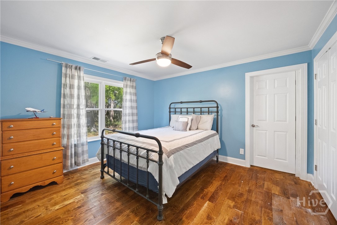 95 Circle Drive Midway, GA 31320 - Photo 11 of 29 Comfortable bedroom with hardwood floors, soft natural light, and calming tones