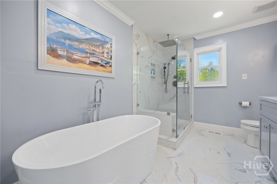 95 Circle Drive Midway, GA 31320 - Photo 15 of 29 Beautifully renovated bathroom featuring a soaking tub, walk-in shower, and elegant finishes