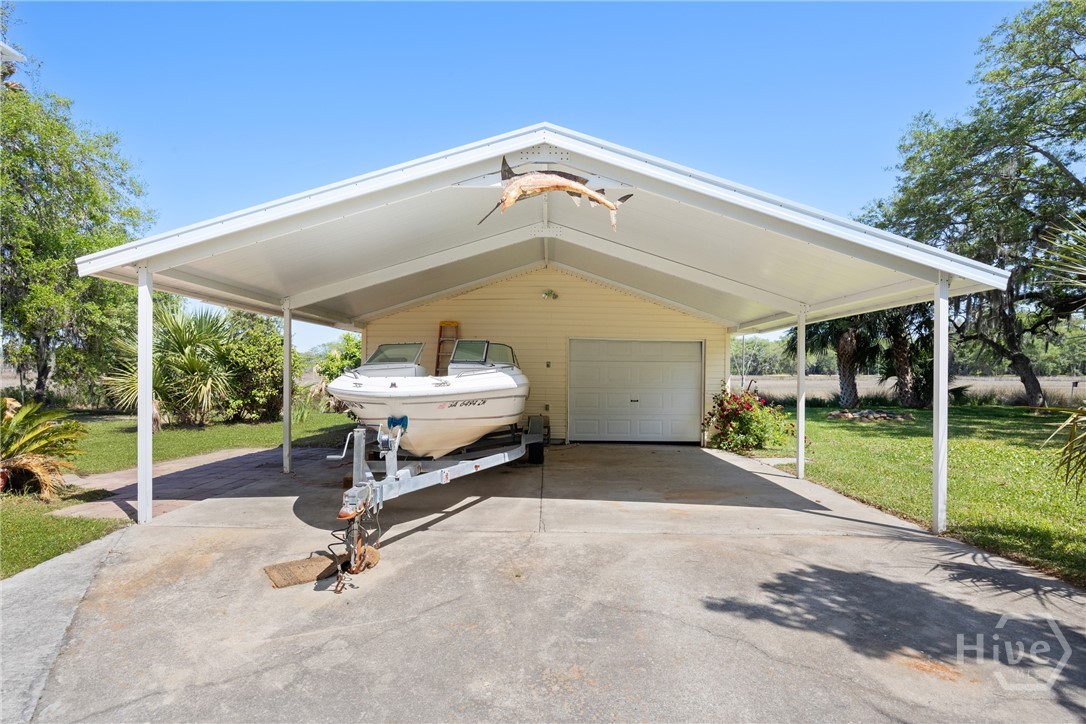 95 Circle Drive Midway, GA 31320 - Photo 19 of 29 Detached garage/workshop with covered parking and boat storage, ideal for outdoor enthusiasts and extra storage needs.