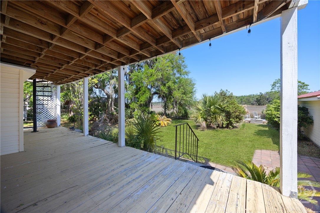 95 Circle Drive Midway, GA 31320 - Photo 20 of 29 Covered back porch overlooking the backyard, a perfect spot to relax and unwind