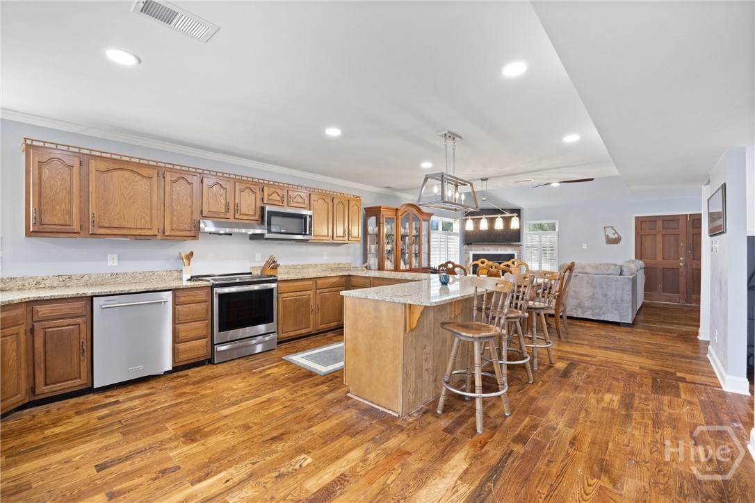 95 Circle Drive Midway, GA 31320 - Photo 10 of 29 Expansive kitchen layout with large island seating, offering plenty of prep and gathering space