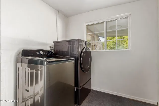 a patio with table and chairs and potted plants
