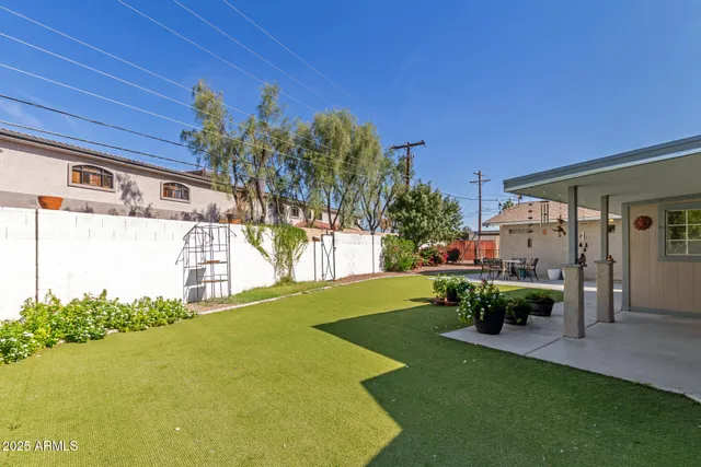 a view of a house with swimming pool and sitting area