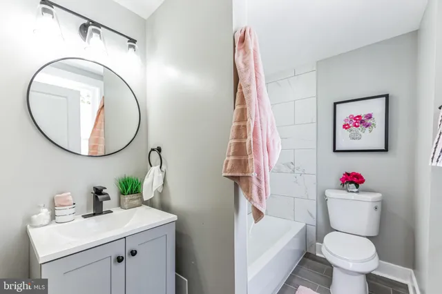 a bathroom with a sink toilet and a mirror
