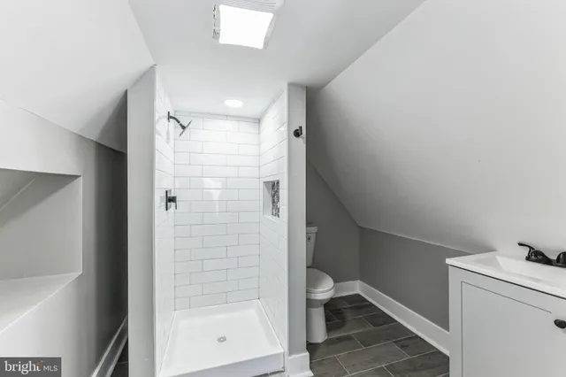 a bathroom with a shower and toilet