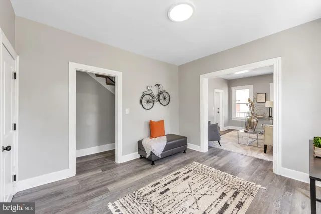 a living room with furniture and a mirror