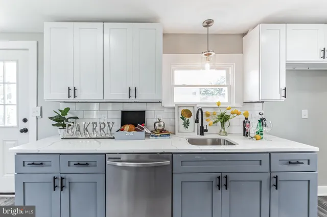 a kitchen with a sink a window cabinets and counter space
