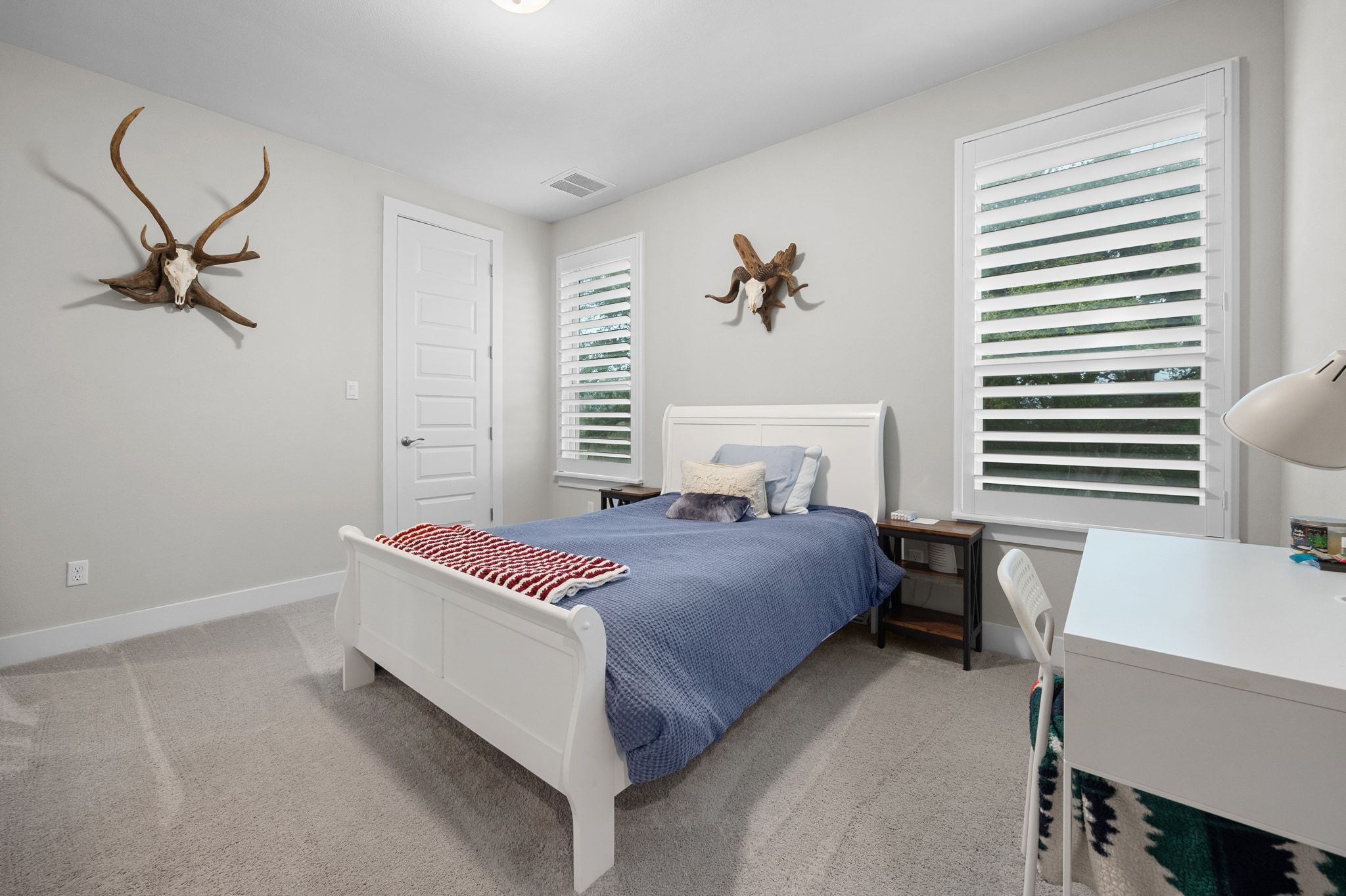 2009 Nature View Loop Driftwood, TX 78619 - Photo 19 of 40 a bedroom with a bed and a chandelier