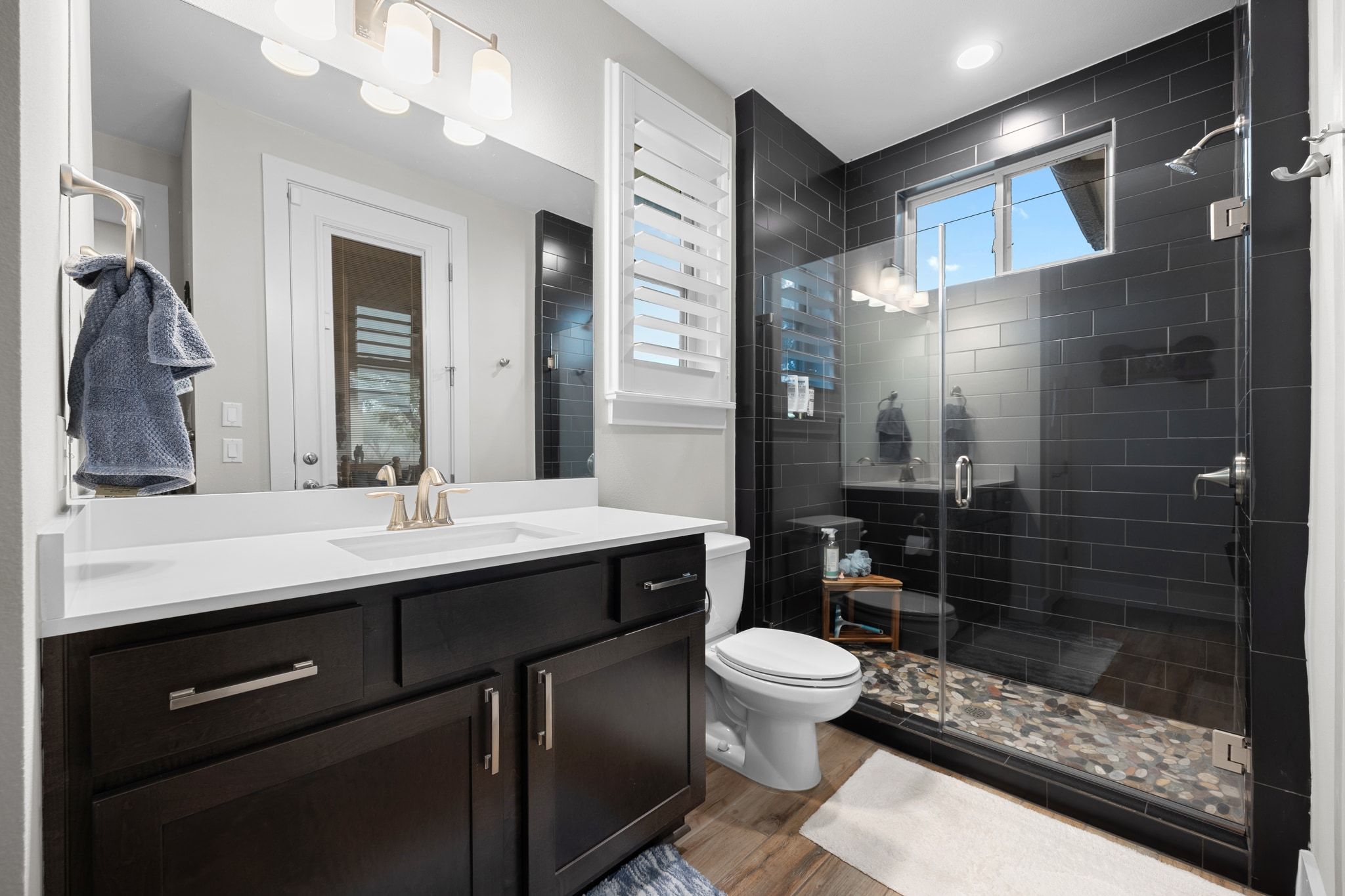 2009 Nature View Loop Driftwood, TX 78619 - Photo 20 of 40 a bathroom with a sink a toilet a mirror and shower