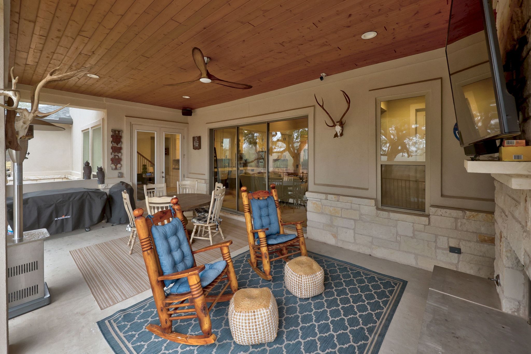 2009 Nature View Loop Driftwood, TX 78619 - Photo 29 of 40 a dining room with wooden floor a glass table and chairs
