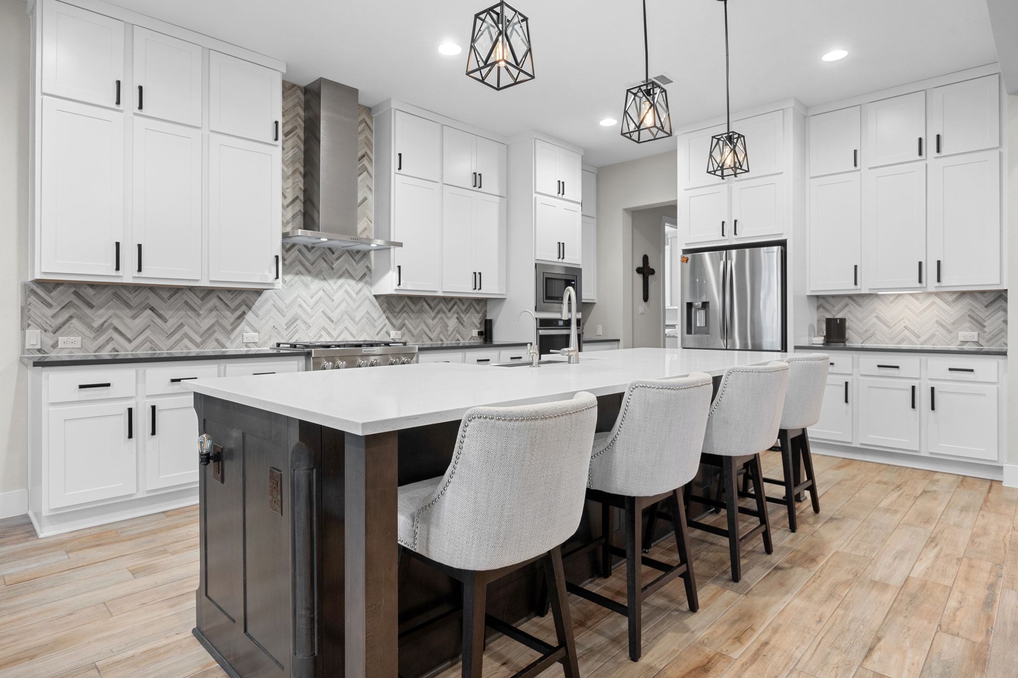 2009 Nature View Loop Driftwood, TX 78619 - Photo 4 of 40 a kitchen with stainless steel appliances granite countertop a kitchen island a stove a table and chairs in it