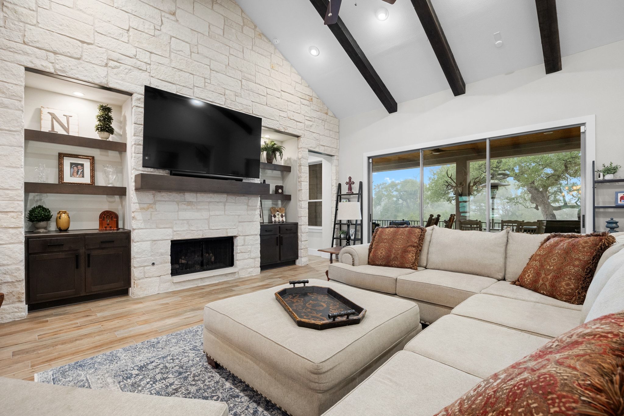 2009 Nature View Loop Driftwood, TX 78619 - Photo 7 of 40 a living room with furniture a flat screen tv and a fireplace