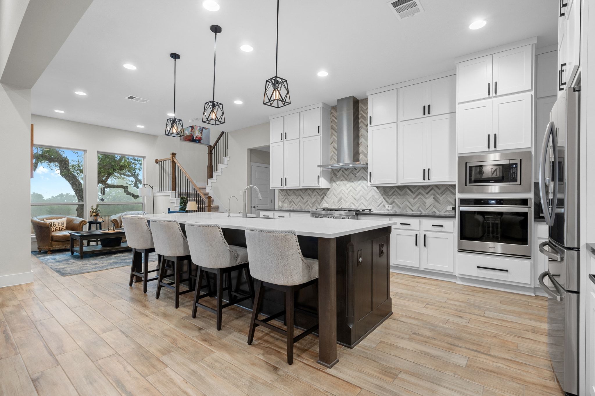 2009 Nature View Loop Driftwood, TX 78619 - Photo 8 of 40 a large kitchen with stainless steel appliances kitchen island granite countertop a large center island attached withe living room