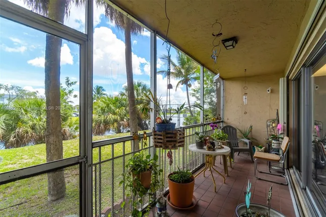 a view of a porch with furniture and garden