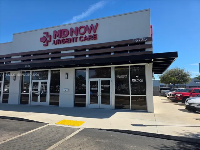 a view of a cars park in front of a building