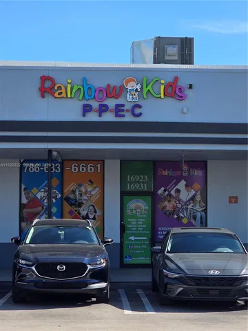 a view of a cars park in front of a building