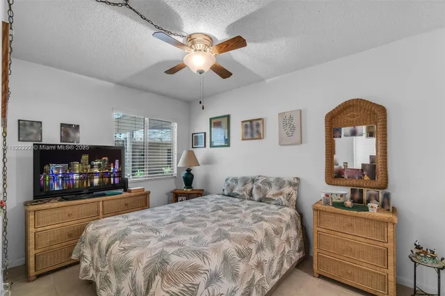 a bedroom with a bed and a television