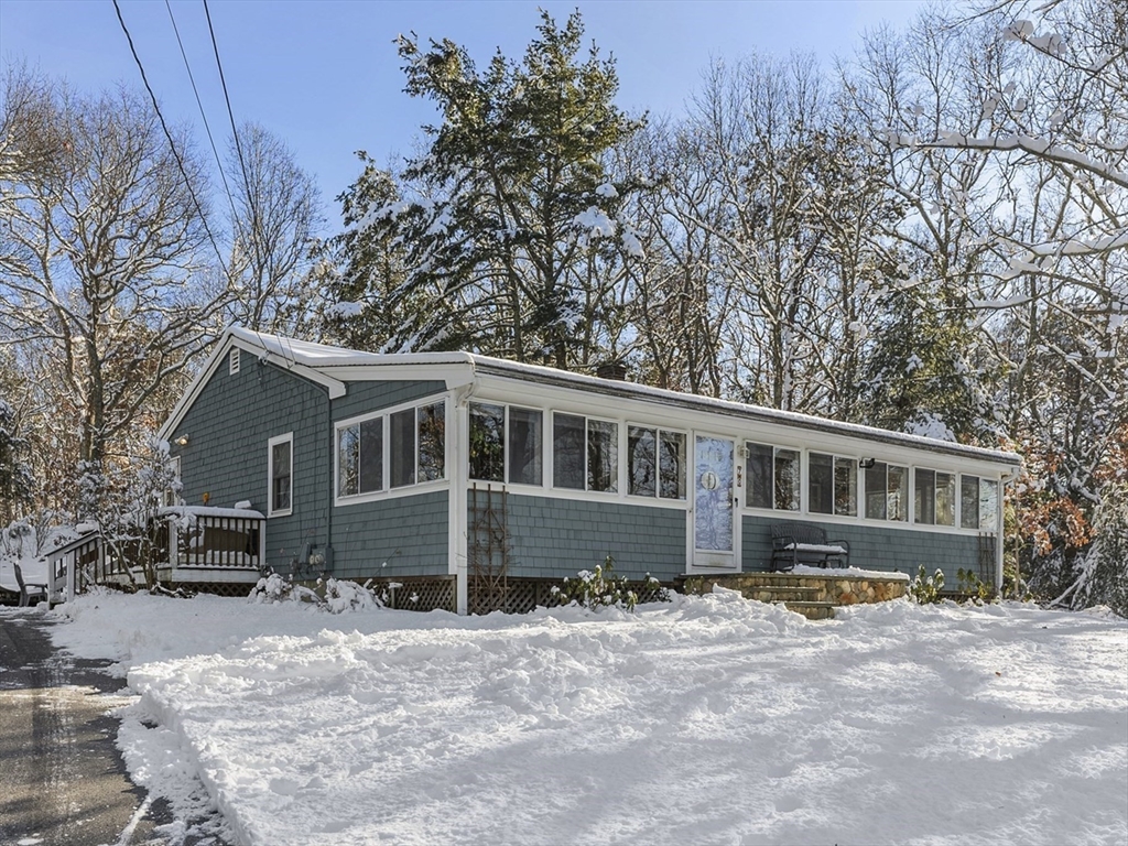 70 7 Hills Road Plymouth, MA 02360 - Photo 1 of 42 a front view of a house with a yard covered with snow