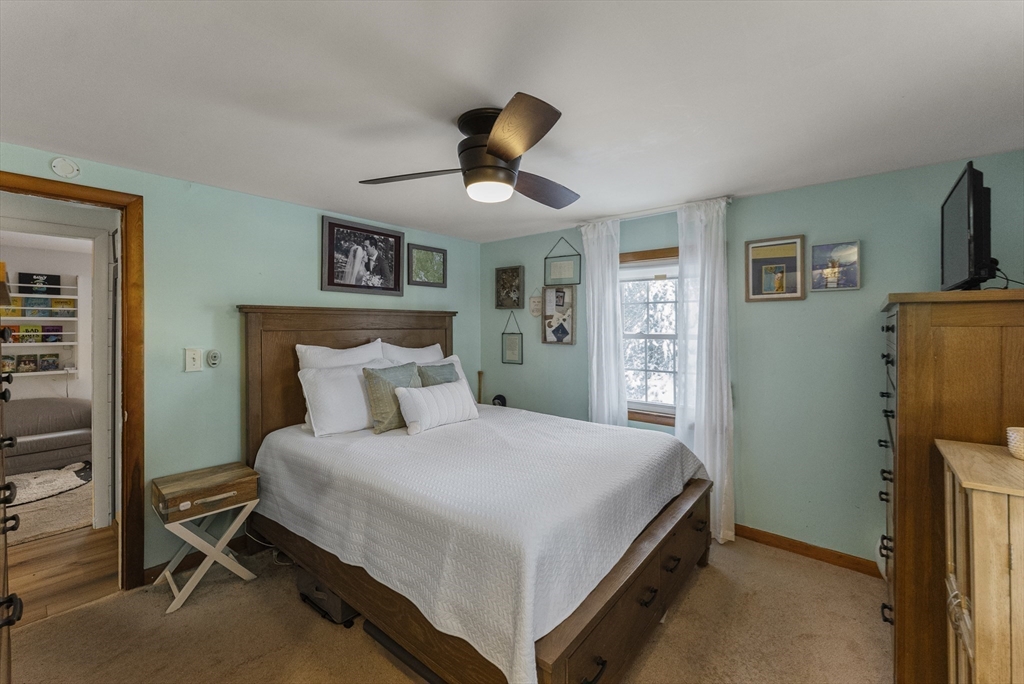 70 7 Hills Road Plymouth, MA 02360 - Photo 19 of 42 a bedroom with a bed and a chandelier