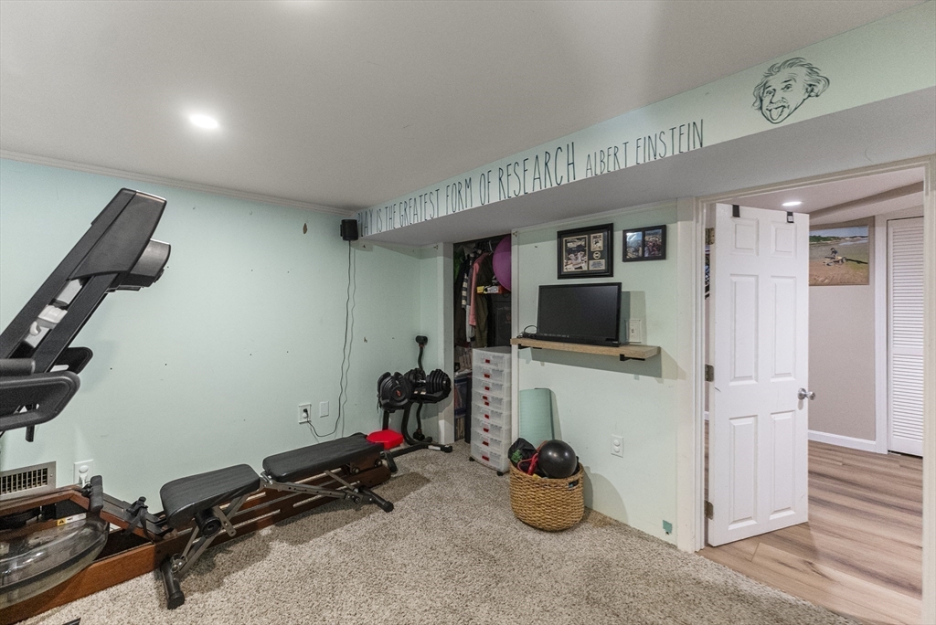 70 7 Hills Road Plymouth, MA 02360 - Photo 28 of 42 a room with gym equipment and a mirror
