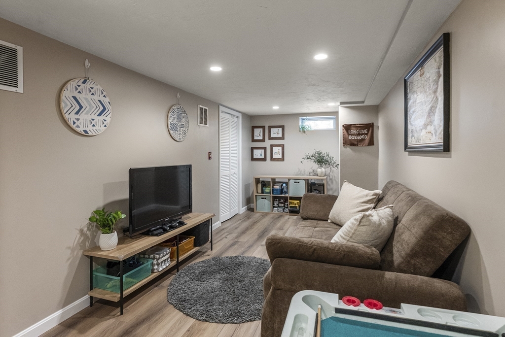 70 7 Hills Road Plymouth, MA 02360 - Photo 29 of 42 a living room with furniture and a flat screen tv