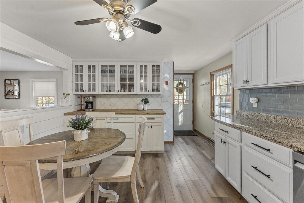 70 7 Hills Road Plymouth, MA 02360 - Photo 3 of 42 a kitchen with stainless steel appliances granite countertop a dining table chairs stove and white cabinets