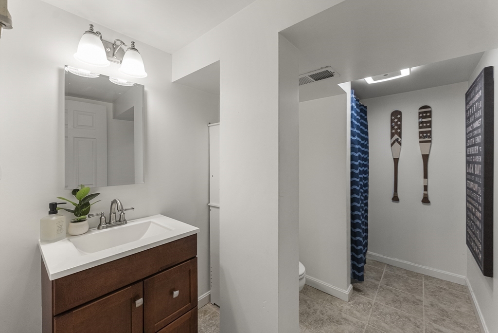 70 7 Hills Road Plymouth, MA 02360 - Photo 32 of 42 a bathroom with a shower sink and mirror