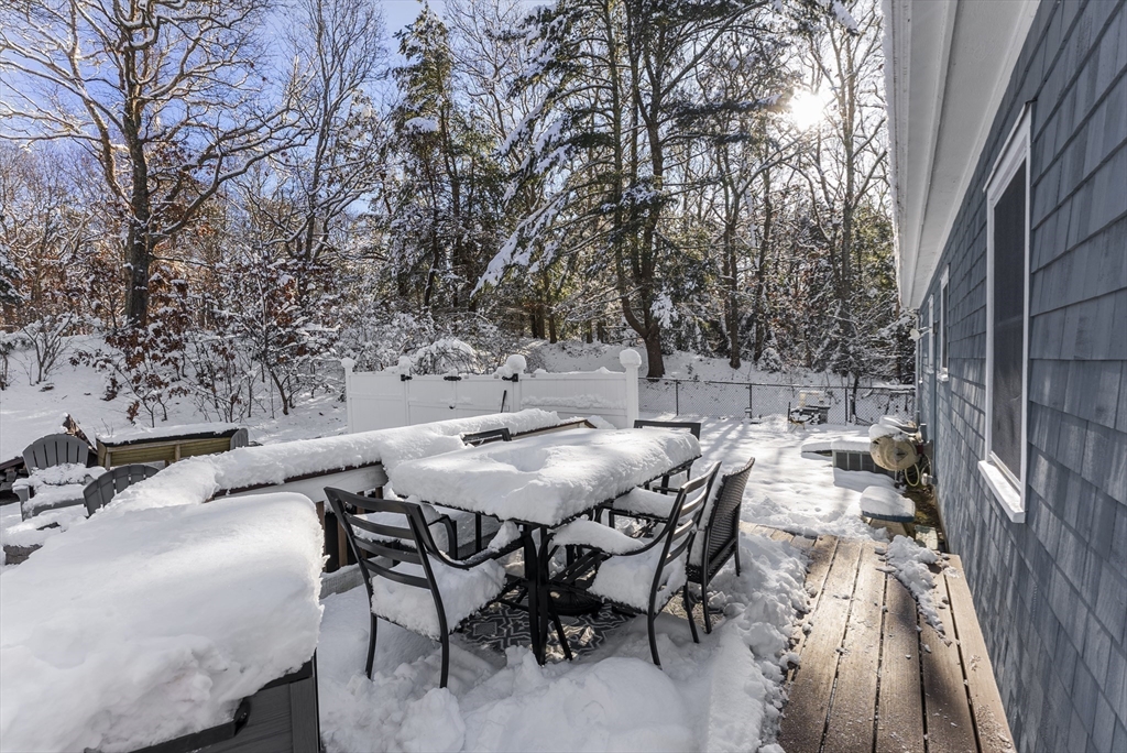 70 7 Hills Road Plymouth, MA 02360 - Photo 36 of 42 a view of a patio with table and chairs and couches with wooden floor and fence