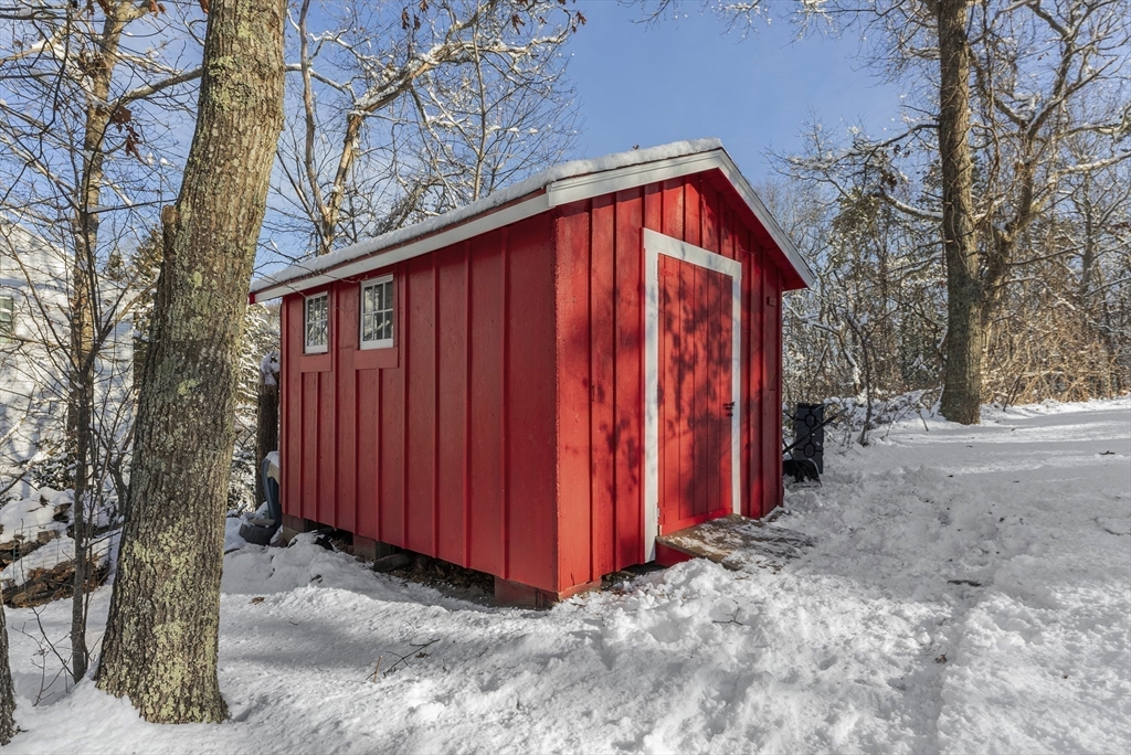 70 7 Hills Road Plymouth, MA 02360 - Photo 40 of 42 a view of a backyard with large trees and wooden fence