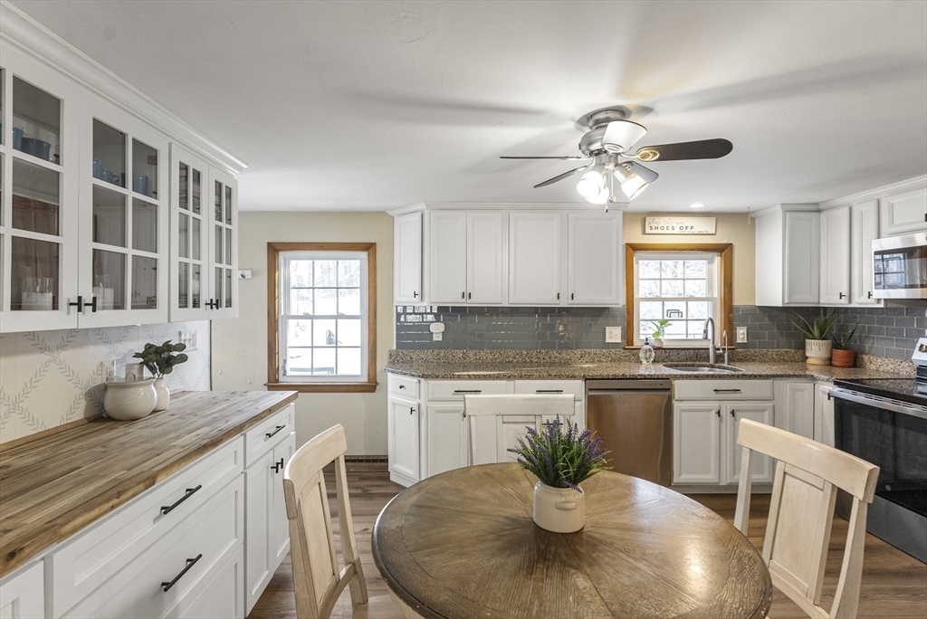 70 7 Hills Road Plymouth, MA 02360 - Photo 5 of 42 a kitchen with stainless steel appliances granite countertop a sink a stove a dining table and chairs