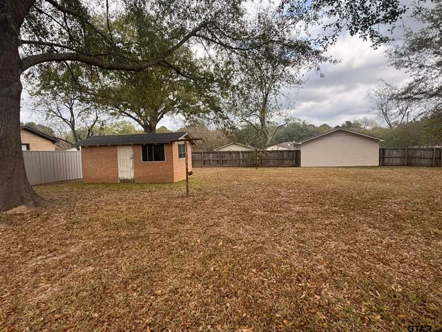 a front view of house with yard and trees