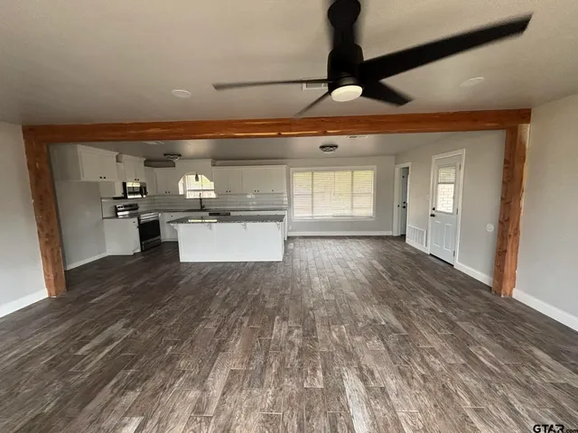 a kitchen with stainless steel appliances granite countertop a refrigerator and a stove top oven