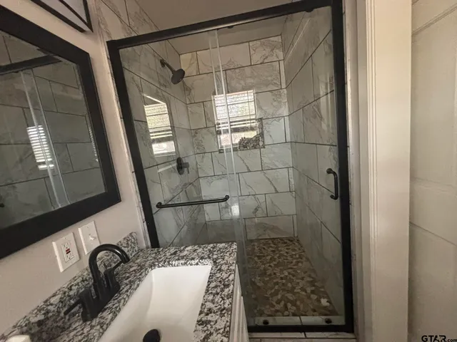 a bathroom with a bathtub and shower