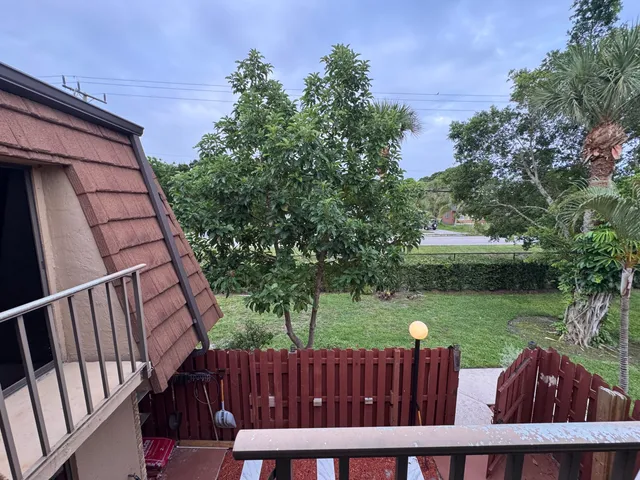 a view of a wooden fence and trees with wooden fence