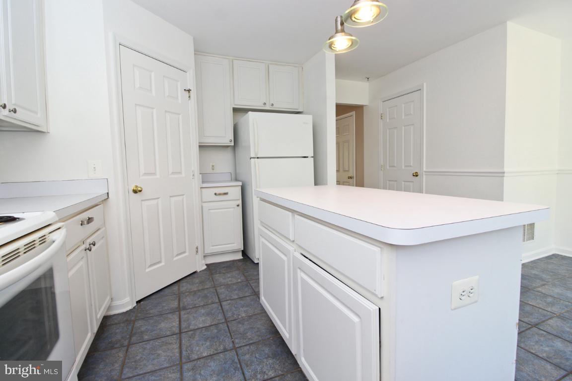 656 Luthardt Road Baltimore, MD 21220 - Photo 11 of 27 a kitchen with white cabinets and white appliances