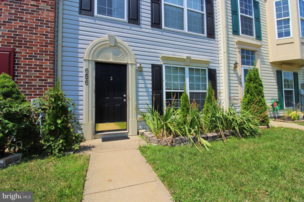 656 Luthardt Road Baltimore, MD 21220 - Photo 3 of 27 a view of yellow house with a small yard and plants