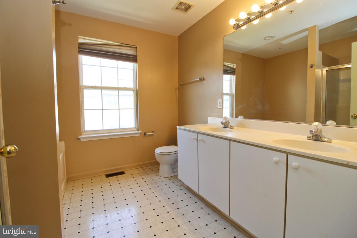 656 Luthardt Road Baltimore, MD 21220 - Photo 27 of 27 a bathroom with a sink a toilet and mirror