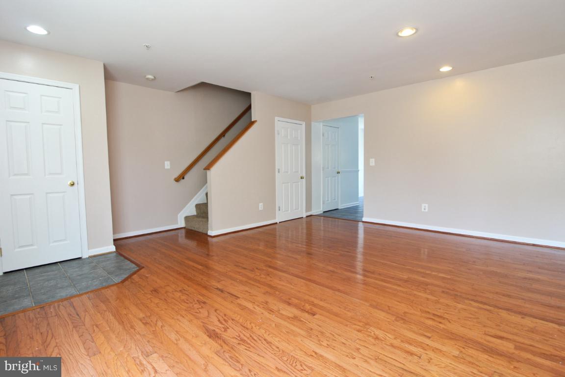 656 Luthardt Road Baltimore, MD 21220 - Photo 4 of 27 a view of empty room with wooden floor and stairs
